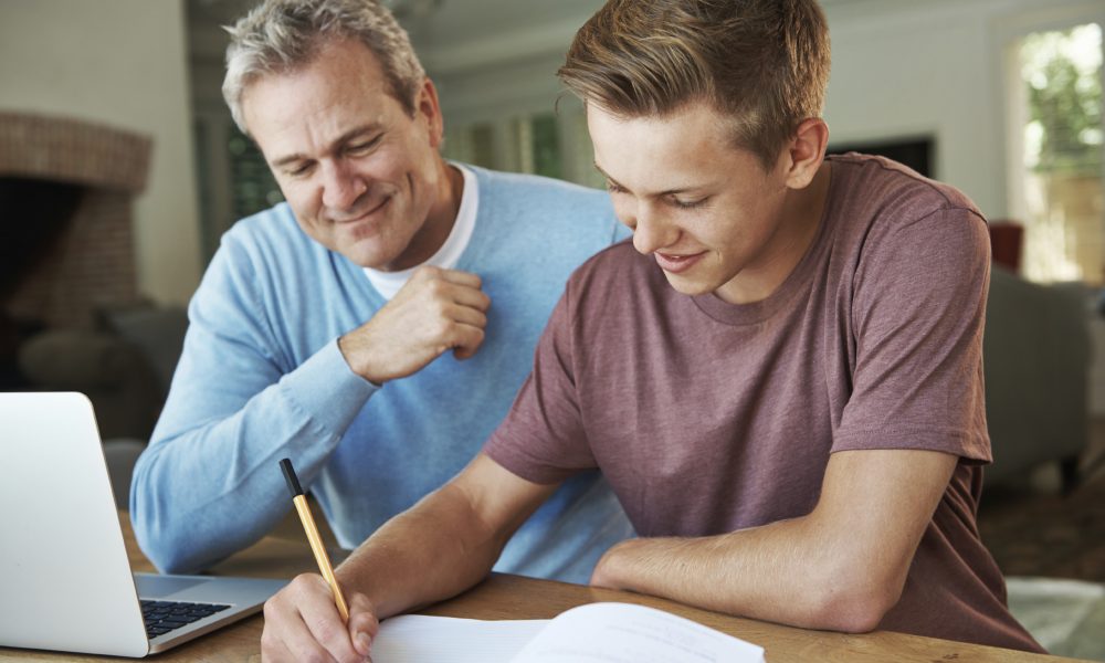 That A+ is definitely going to be yours! A father helping his teenage son with his homework